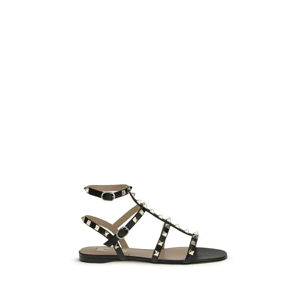 Valentino Garavani Schwarze Bos Taurus Kalbsleder Sandalen mit flacher Sohle