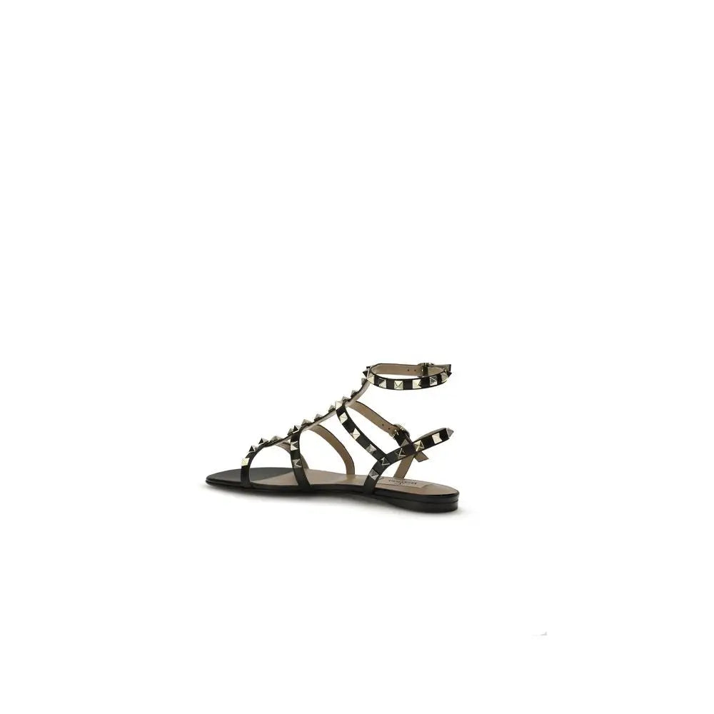Valentino Garavani Schwarze Bos Taurus Kalbsleder Sandalen mit flacher Sohle
