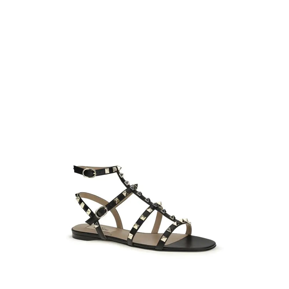 Valentino Garavani Schwarze Bos Taurus Kalbsleder Sandalen mit flacher Sohle